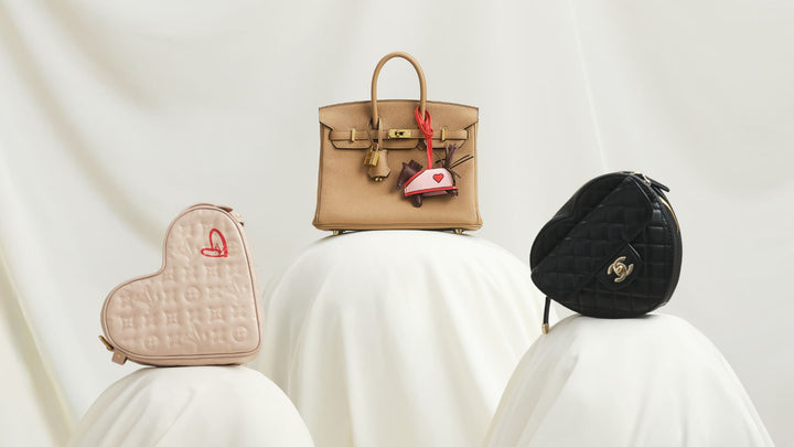 Three Valentine's Day limited-edition ultra-luxury handbags on a fabric pedestal.