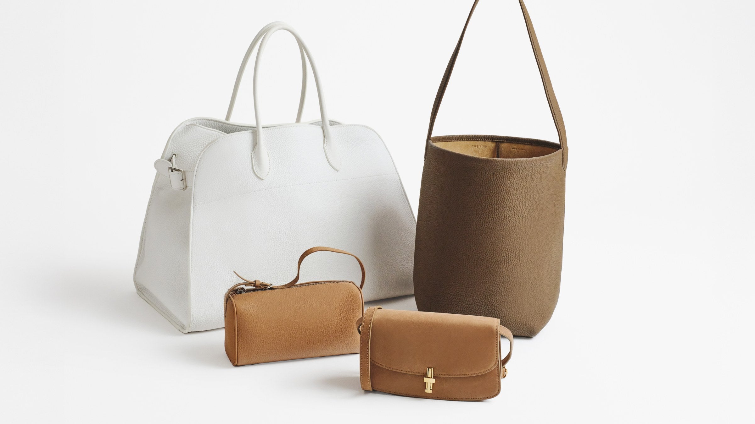 The Row's Margaux, 90's Bag, Park tote, and Sofia facing center at an angle to one another.