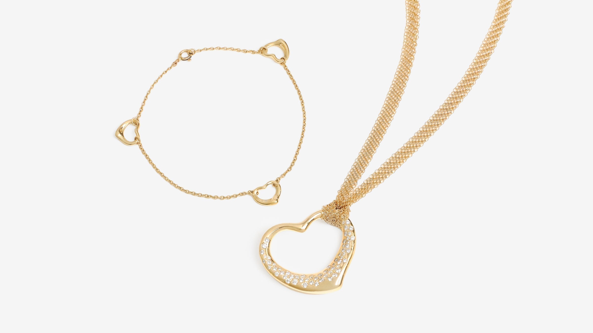 A Gold Tiffany Open Heart necklace and bracelet by Elsa Peretti.