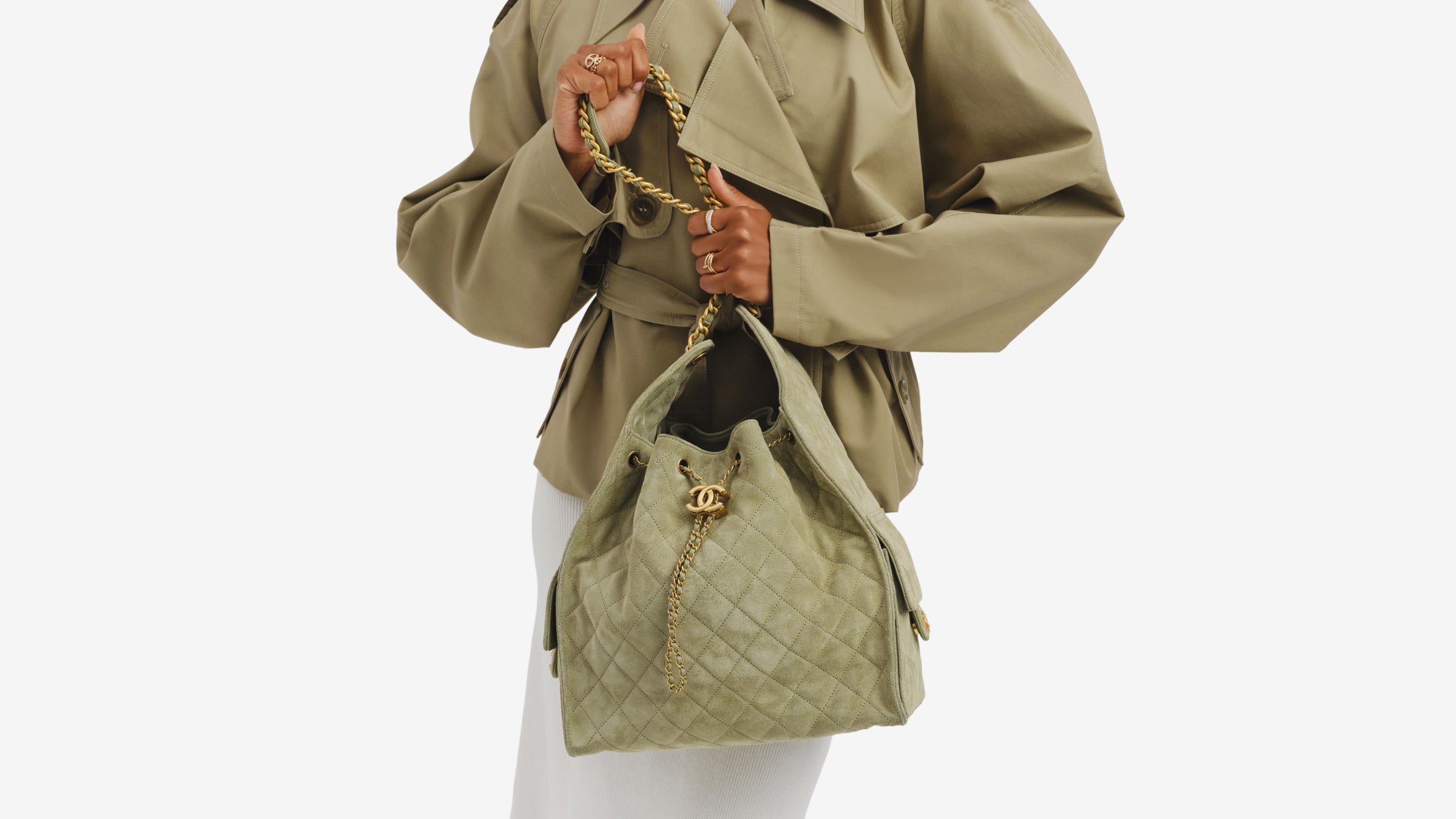 Model carrying a green Chanel 25 handbag