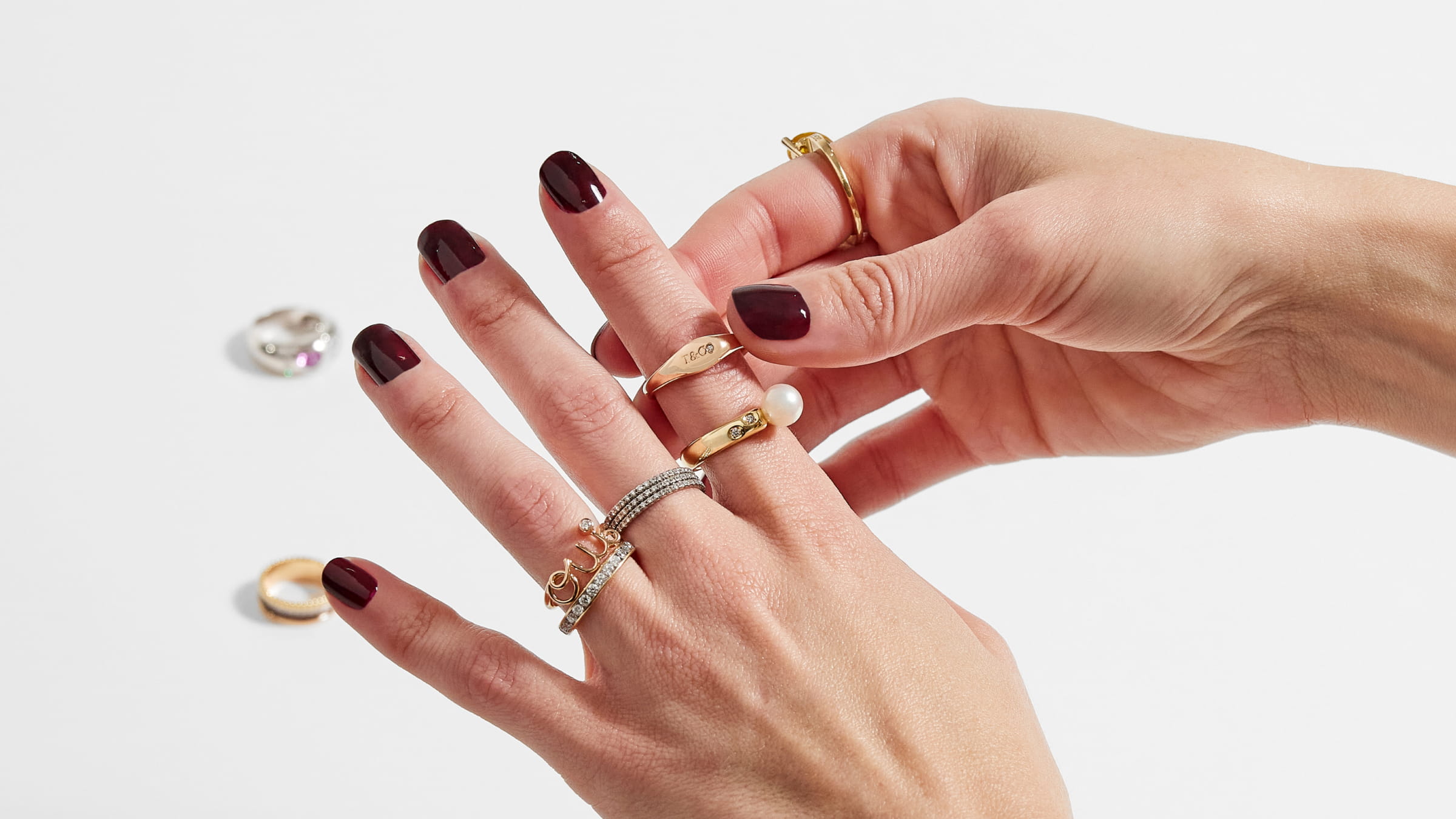A hand putting on ultra-luxury rings