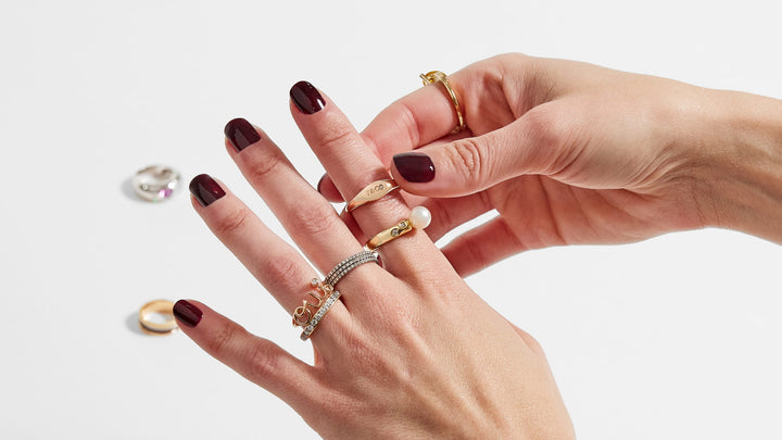 A hand putting on ultra-luxury rings