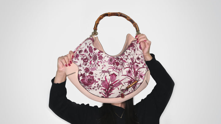Model holds vintage Gucci bag to her face