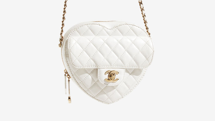 A dangling Chanel Lambskin Quilted CC In Love Heart Bag in White