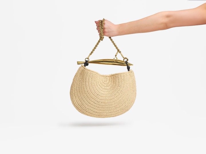 Hand holding a Bottega Veneta Sardine bag