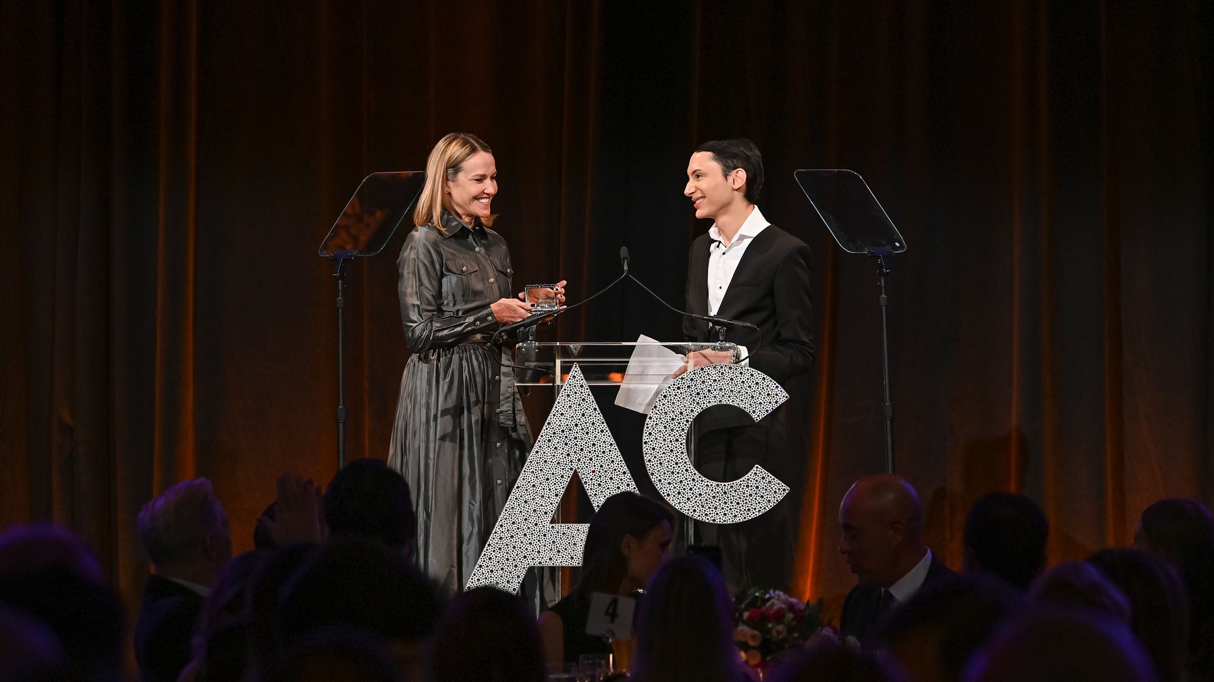 image of Fashionphile founder and president sarah davis accepting the 2023 ACE award for retail innovation presented by Charles B Gross FASHIONPHILE