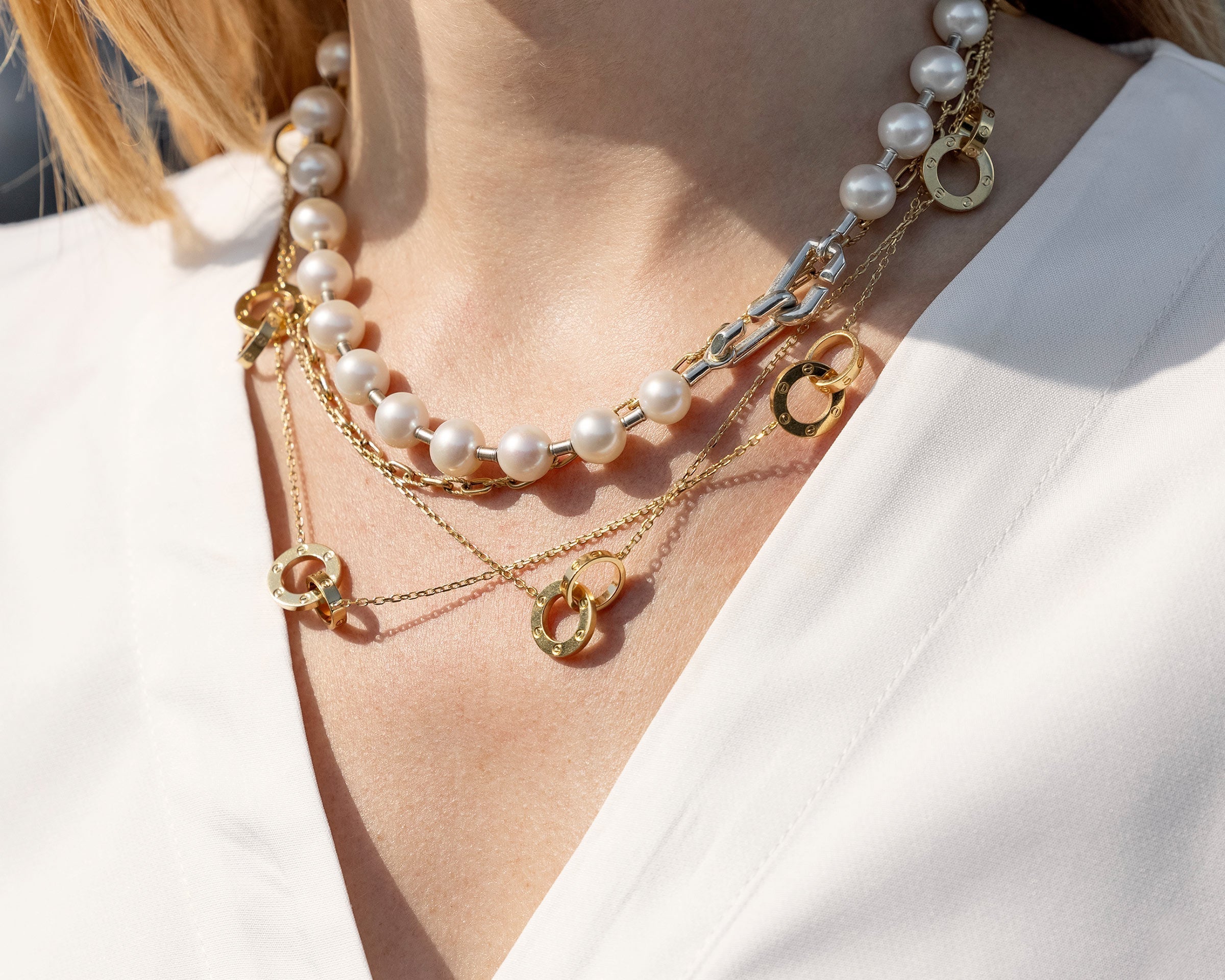 lifestyle image of model wearing pearl tiffany necklace with layered gold necklace at FASHIONPHILE