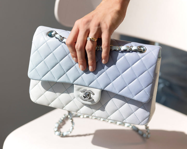hand with engagement ring reaching out for ombre blue and white Chanel quilted Double Flap bag FASHIONPHILE