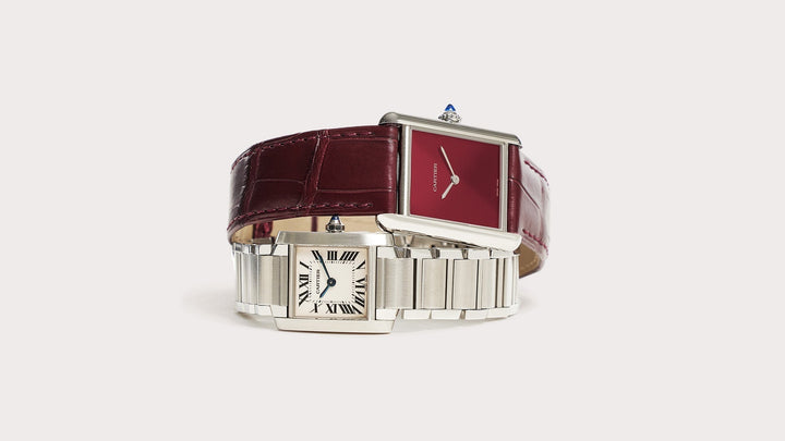 studio image of cartier tank watches stacked on flat surface FASHIONPHILE