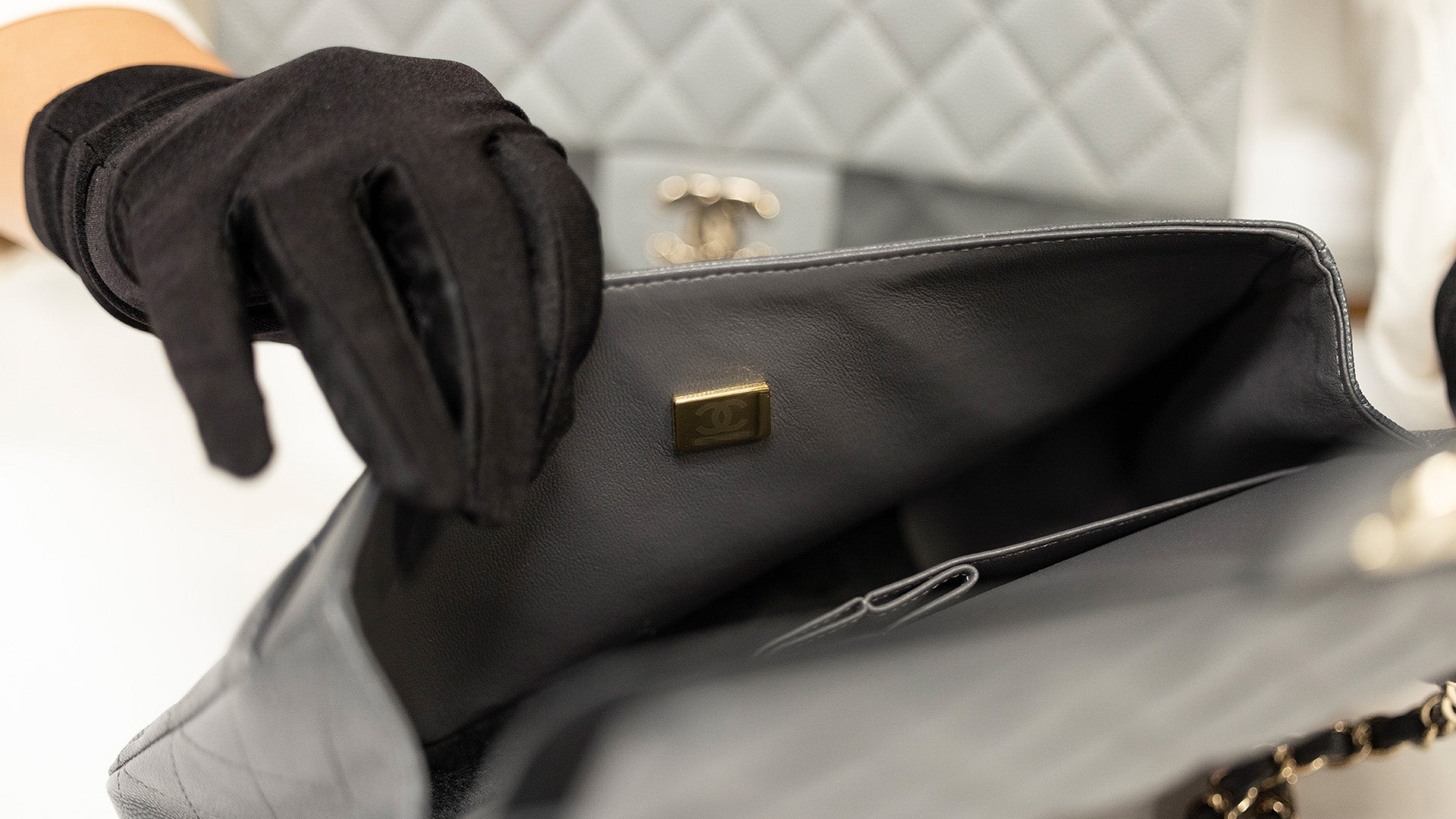 image of brand authenticator checking Chanel microchip FASHIONPHILE