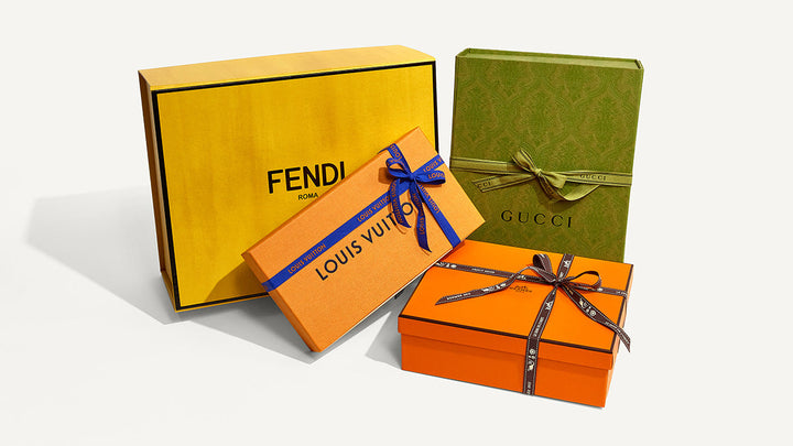 studio image of Fendi, Louis Vuitton, Gucci, and Hermes designer boxes FASHIONPHILE