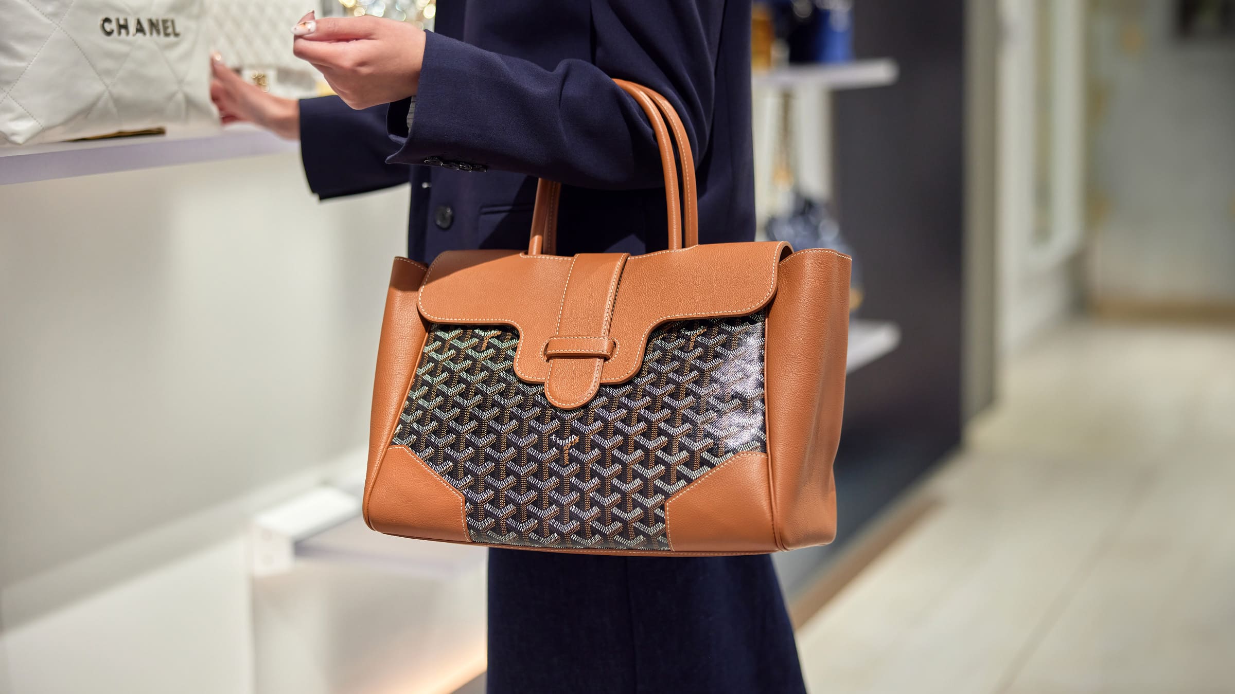 the new goyard saigon tote in black and gold worn on the arm by FASHIONPHILE