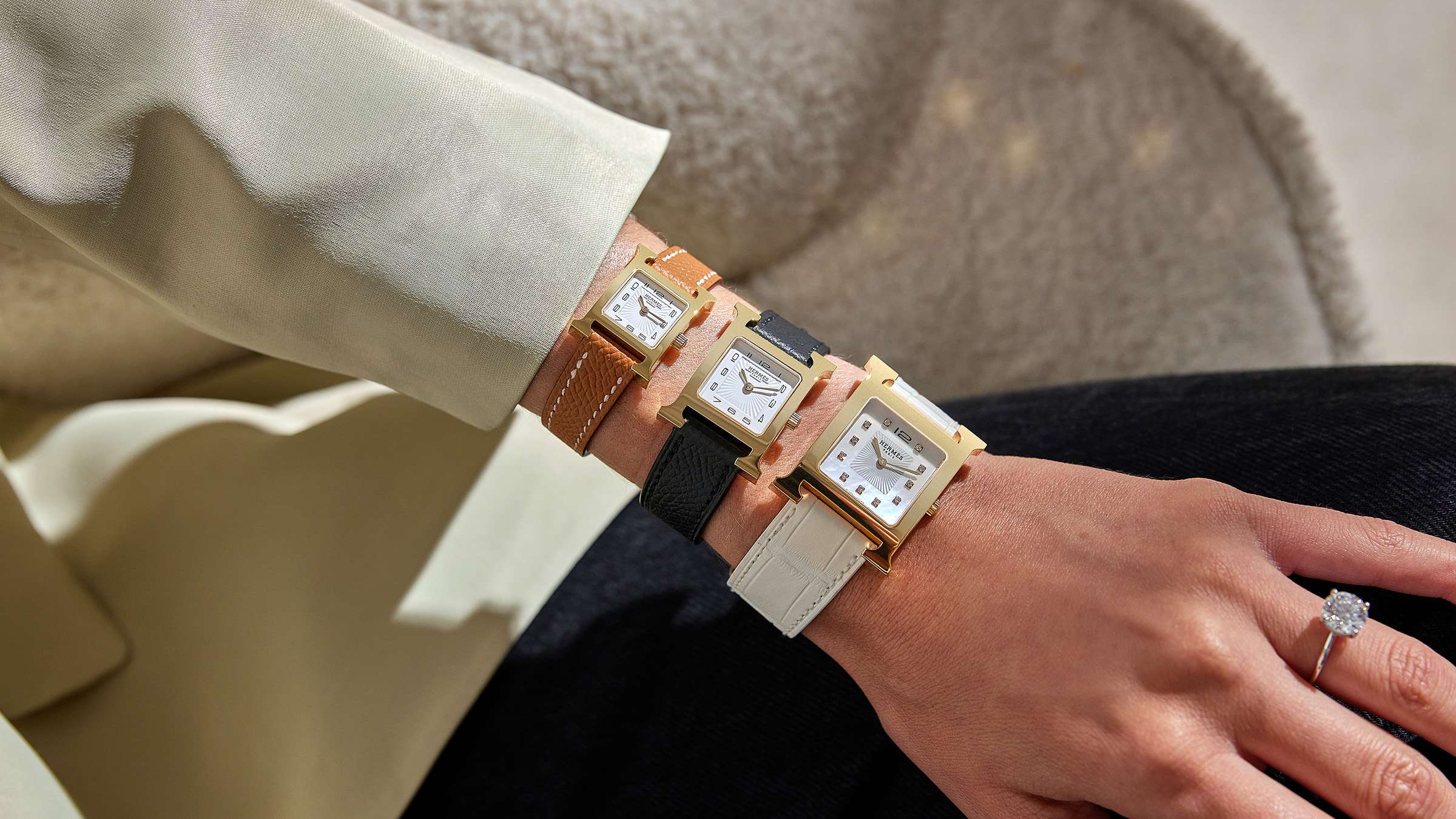 Top view of three different sized Hermes Heure H watches from smallest to biggest by FASHIONPHILE