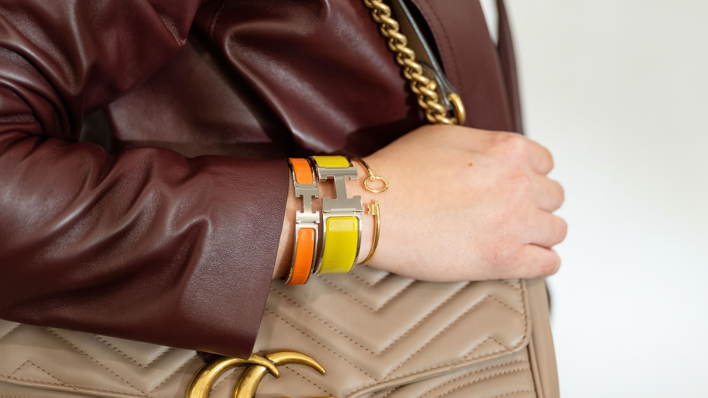 styling a stack with an hermes clic h bracelet, an hermes clic clac h bracelet and a tiffany bracelet by FASHIONPHILE