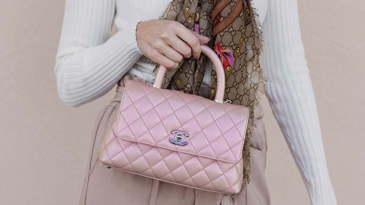 lifestyle image of model holding chanel iridescent coco handle bag FASHIONPHILE