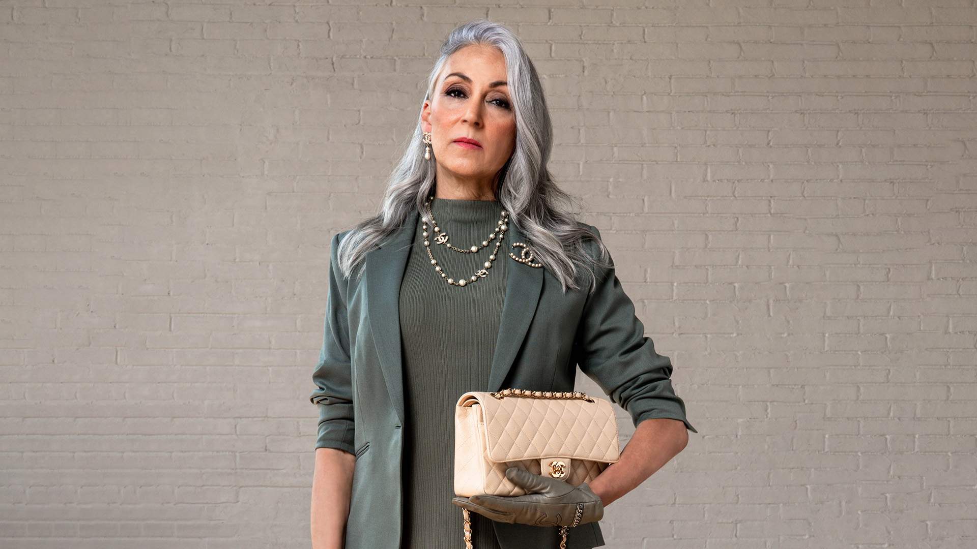 model wearing chanel jewerly with chanel flap bag FASHIONPHILE