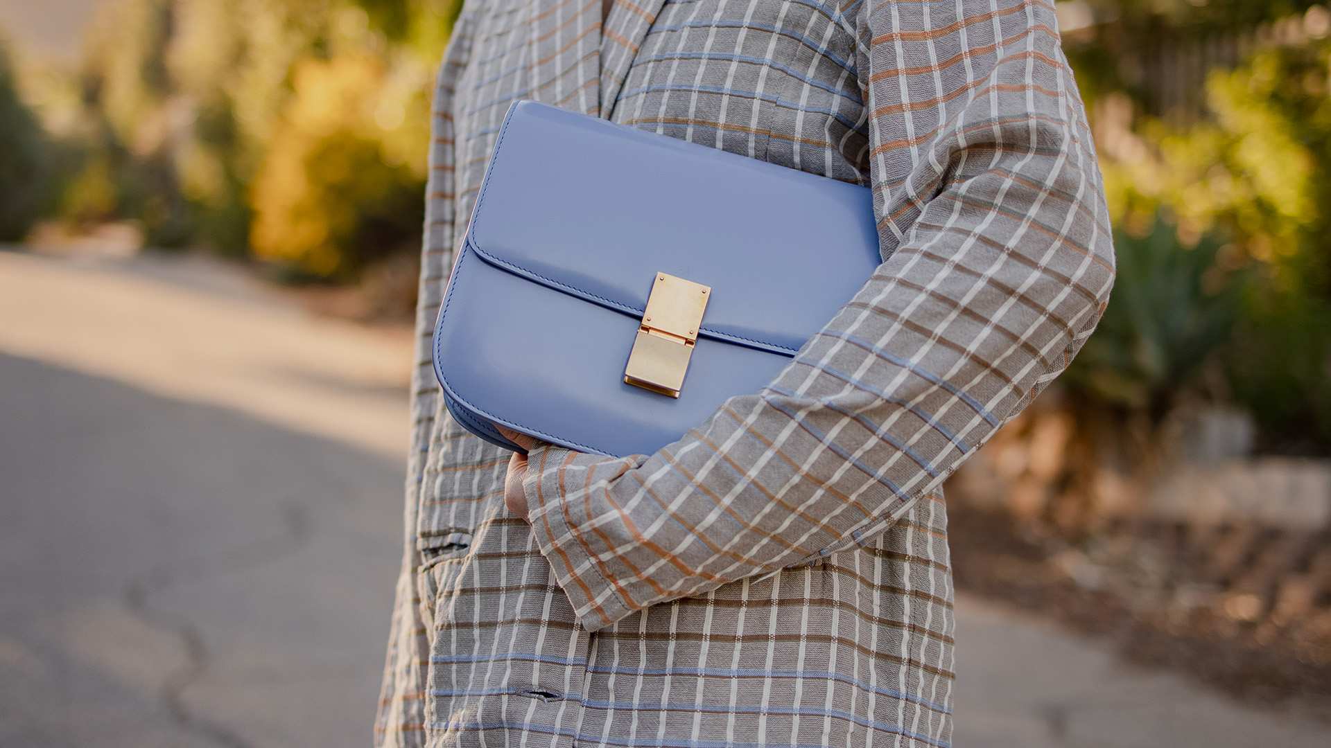 lifestyle image of model holding blue celine box bag FASHIONPHILE