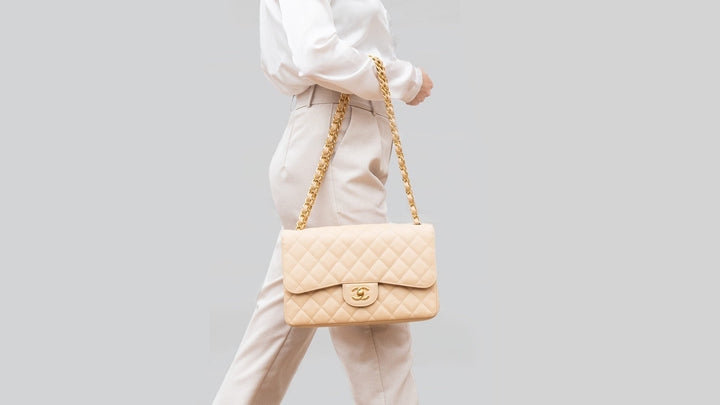 lifestyle image of model wearing beige chanel caviar flap FASHIONPHILE