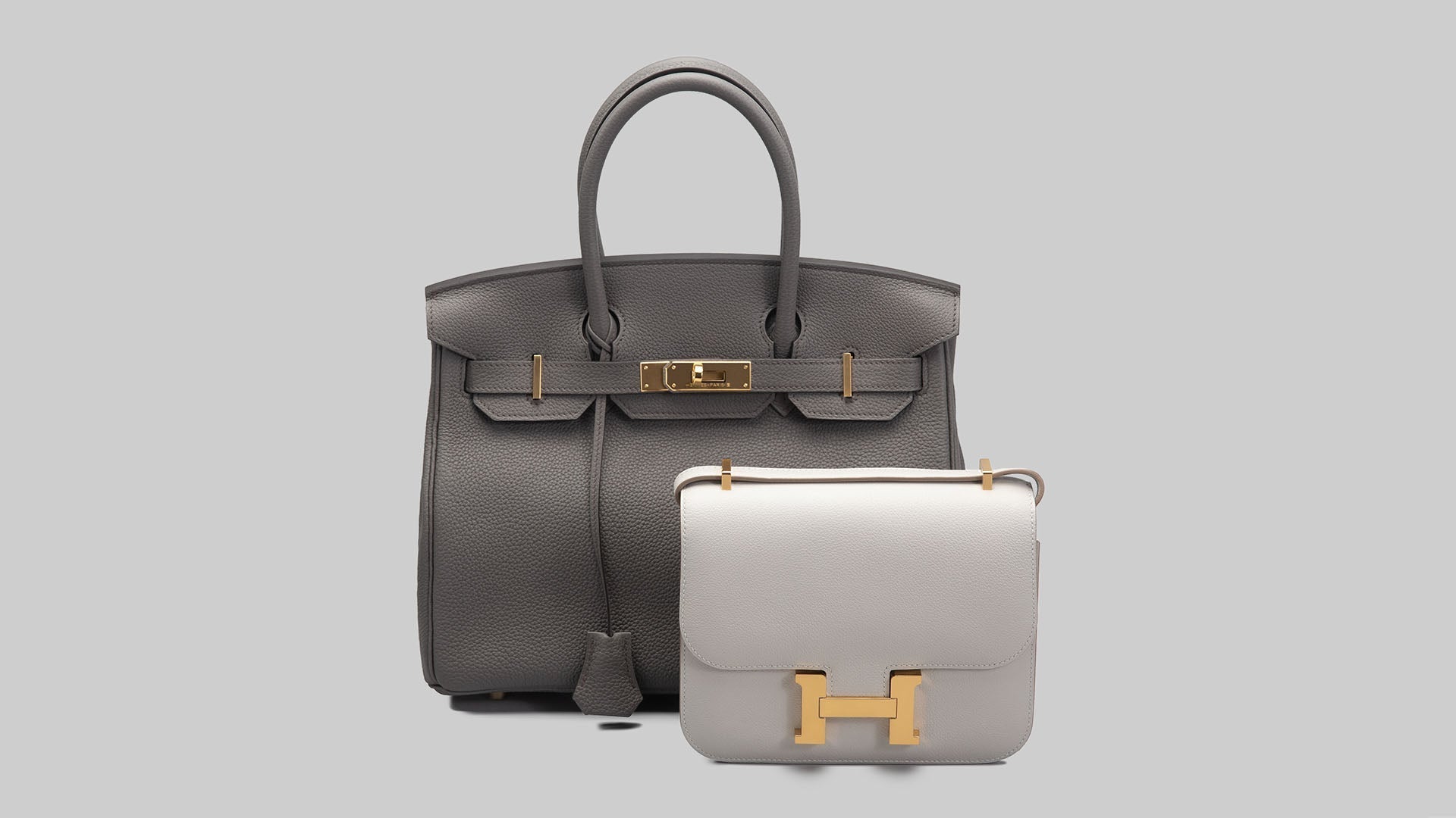 Studio image of Hermes Birkin bag and Clemence bag Grey FASHIONPHILE