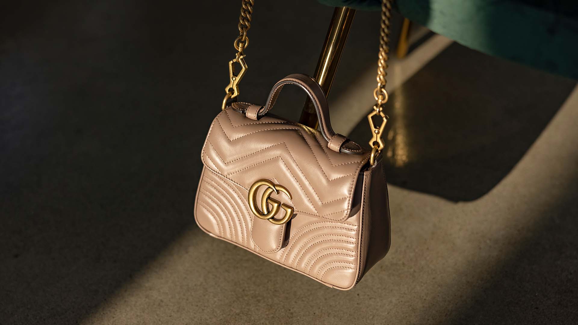 Lifestyle image of Authentic Gucci Marmont Top Handle Bag in beige at FASHIONPHILE