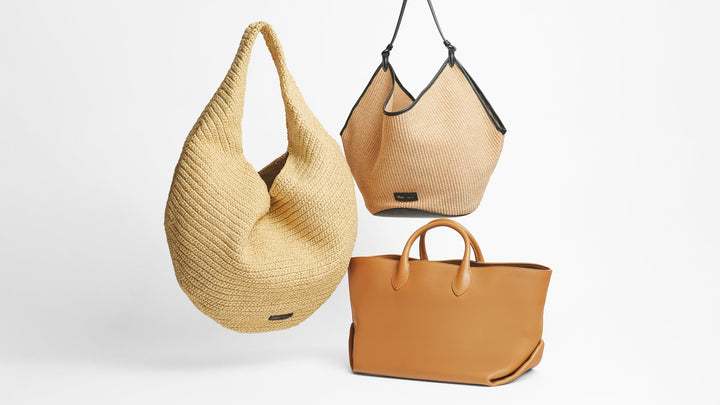 Image of a Khaite Lotus and Olivia bag suspended in the air with a Khaite Amelia on the ground