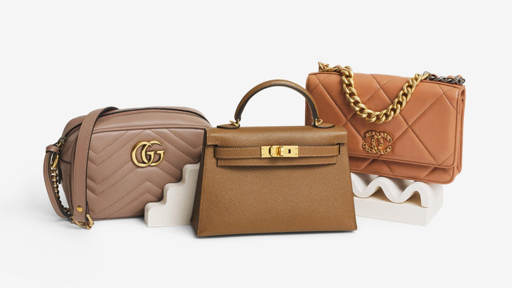 Gucci Calfskin Matelasse Mini GG Marmont Chain Shoulder Bag Porcelain Rose, Hermes Epsom Mini Kelly Sellier 20 Alezan, and a Chanel Lambskin Quilted Chanel 19 Wallet On Chain WOC Brown in the center of the frame on a step riser