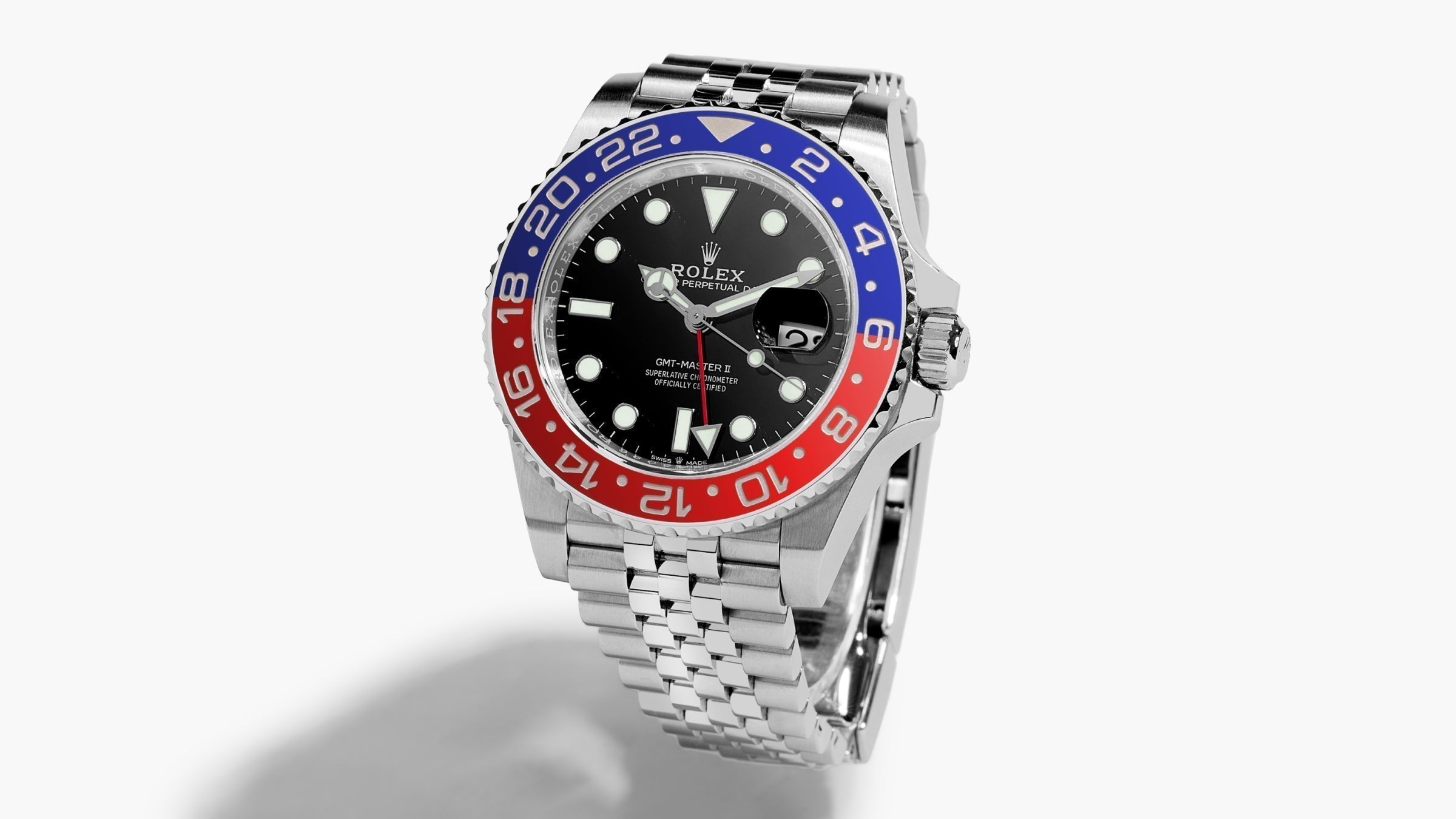 Picture of an upright Rolex on a white surface with a drop shadow