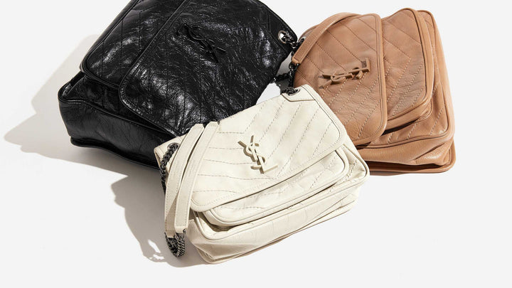 this is a laydown image of all three saint laurent niki chain satchel sizes grouped together by FASHIONPHILE