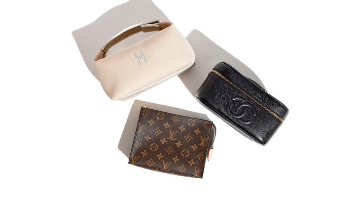 Luxury toiletry bags from Hermes, Chanel, and Louis Vuitton grouped together by FASHIONPHILE