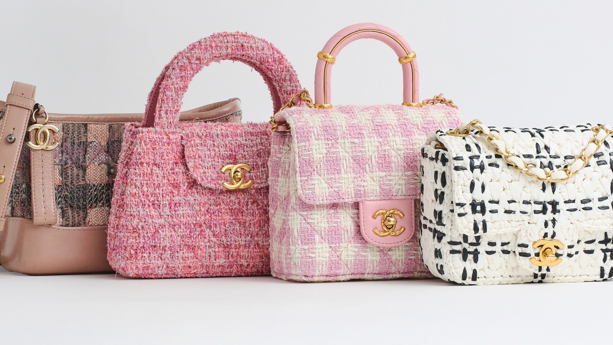 Lineup of different Chanel bags in Tweed showcased in shades of pink and black and white