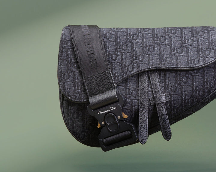 studio image of men's dior saddle bag FASHIONPHILE